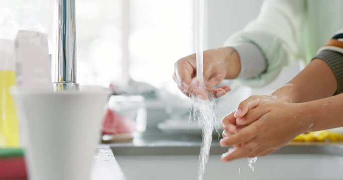 Kid, washing and hands with mom with foam for learning about hygiene in kitchen for germs. Water, youth and tap with woman or soap in home for bacteria or natural skincare for safety from virus.