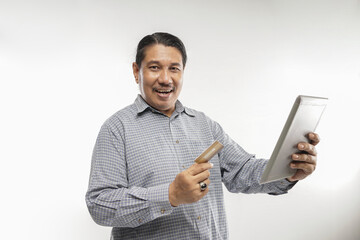 old asian man standing with holding credit card and tablet in white background isolated