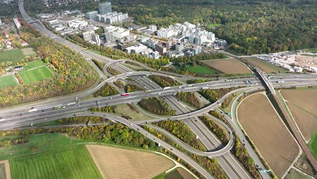 Aerial drone view of a multi-level highway intersection with moving cars near the city of Stuttgart, Germany. Trucks move along a multi-level road junction. The concept of the urban.