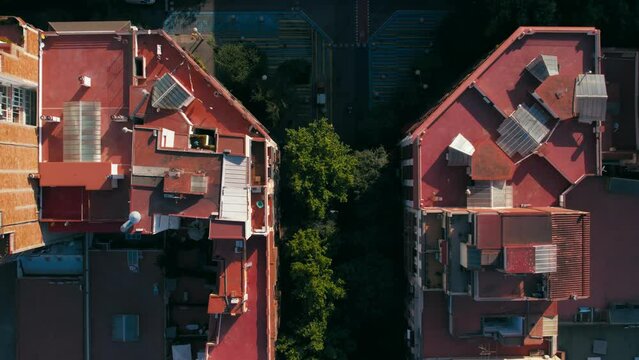 Top down drone view on characteristic grid building blocks with chafered corners of Barcelona Eixample district. Intersection and junction, streets lined with trees, bicycle lanes and pedestrian areas