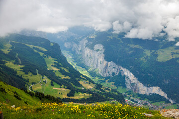 view from Männlichen through clouds into Lauterbrunnen valley