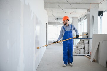 painter man painting the wall, with paint roller