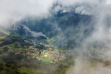 view from Männlichen through clouds on Wengen in Lauterbrunnen valley