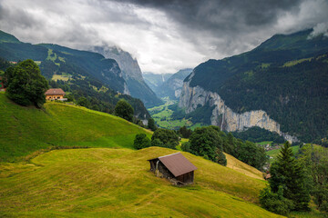 view from Wengen with farm shed through clouds into Lauterbrunnen valley