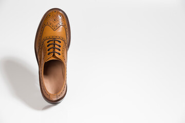 One Brogue Derby Shoe of Calf Leather with Rubber Sole Over Pure White Background