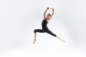 Ballet Dancer Young Caucasian Athletic Man in Black Suit Posing Dancing in Studio On White.