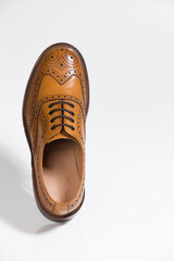 One Brogue Derby Shoe of Calf Leather with Rubber Sole Over Pure White Background.