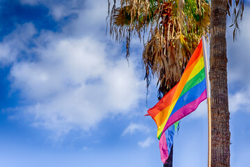 LGBT Flag on Gran Canaria Island in Spain in Maspalomas Against Blue Sky.