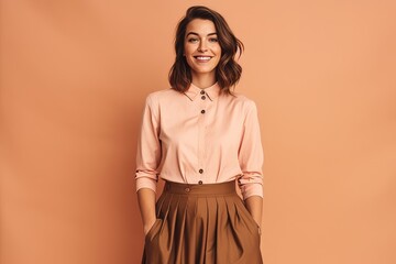 smiling young woman in blouse and skirt on beige background
