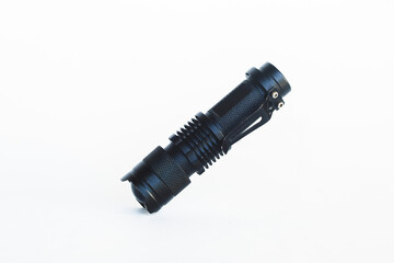 Black tactical flashlight. Outdoor flashlight isolated on white background