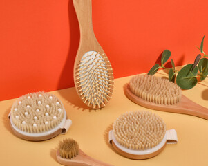Fototapeta na wymiar Several wooden brushes of different sizes for showering and massaging, comb for hair care. Massage and spa products.