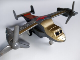 child toy in the form of an airplane with 2 left and right gray propellers on an isolated white...