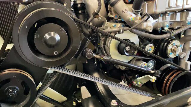 Clean engine car. Close up video shot of belt pulley bus engine. The engine of the bus. Detail of the car engine. The belt pulley compressor, generator, crankshaft - Industrial transportation footage