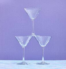 Pyramid composition with glasses for cocktails and other alcoholic beverages on the table. Detail of cocktail party table.
