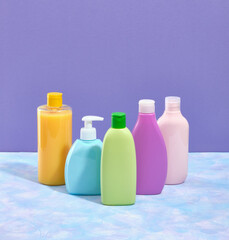 Hygiene self care products. Colorful bottles of shower gels and shampoos, liquid soap. Copy space for text.