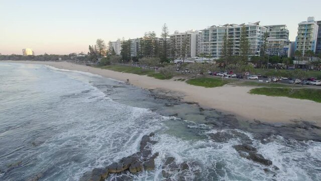Sandy Shores With Moden Built Structures On The Coastline At Mooloolaba Foreshore Reserve In Queensland, Australia. aerial pullback