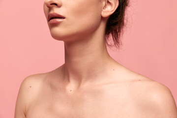 Cropped image of tender naked female body, shoulders and neck against pink studio background. Massage, spa. Concept of female beauty, body care, fitness, sport, health, figure, ad