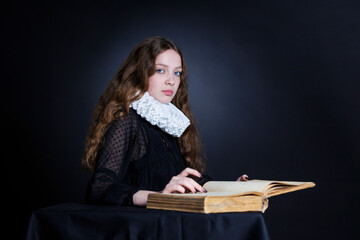 Portrait of a young woman with an open book in the Renaissance style. - 622584759