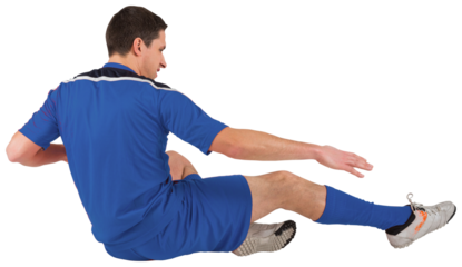 Digital png photo of caucasian male soccer player slide tackling on transparent background