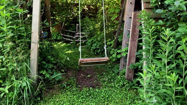 Slow motion, Empty swing set swing in the garden