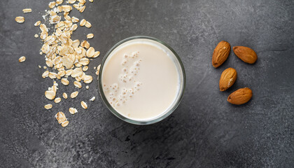 A glass of lean oatmeal milk on a stone background. vegetarian and organic drink food. top view.