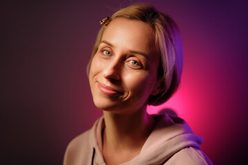 Colorful studio portrait of a happy young woman with a short blonde hair