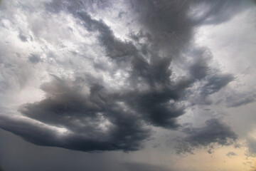 Obraz premium Dark thundercloud in a gray sky on a rainy morning in Inningen near Augsburg, Germany
