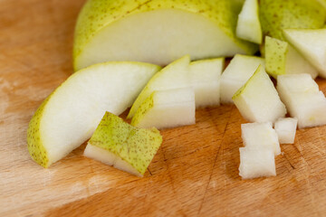 sliced green pear on a wooden board close-up