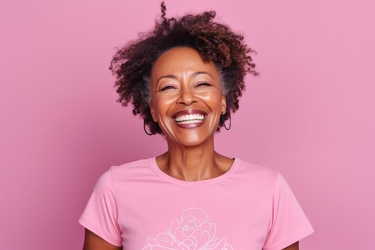 Portrait Of Happy African American Woman Laughing And Looking At Camera Isolated Over Pink Background