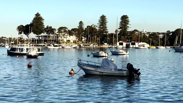 Moored Motor Boat close-up, yachts and Royal Freshwater Bay Yacht Club on Swan River at Peppermint Grove, Perth, Western Australia