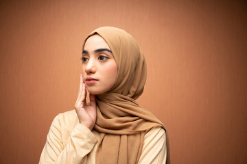 happy mixed race women hijab beauty photo in orange background