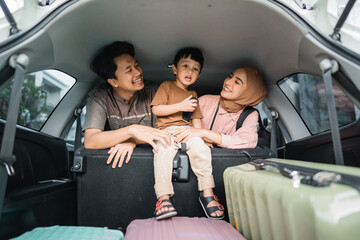 happy asian muslim family going on road trip back home during eid mubarak celebration