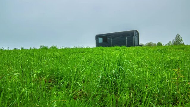 long time lapse of the clouds and sun over a camp trailer in a field of lush wheat
