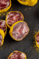 marinated in young turmeric pork sausage on black slate