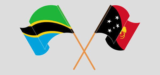 Crossed and waving flags of Tanzania and Papua New Guinea