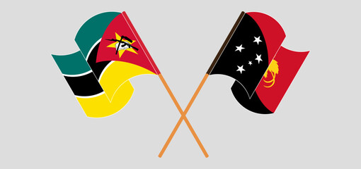 Crossed and waving flags of Mozambique and Papua New Guinea
