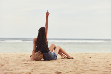 Fototapeta na wymiar caucasian woman beach travel nature sand sea vacation sitting freedom smile