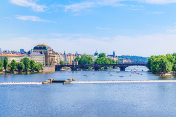Obraz premium View of River Vltava in Prague, Czech Republic. People enjoy summertime using recreational boats