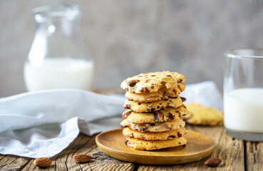 Florence cookies or fiorentine biscuits with almonds on wooden table with glass of milk and milk jug