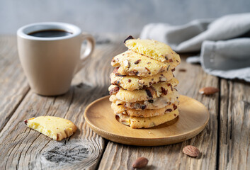 Florence cookies or fiorentine biscuits with almonds on wooden table with cup of coffee