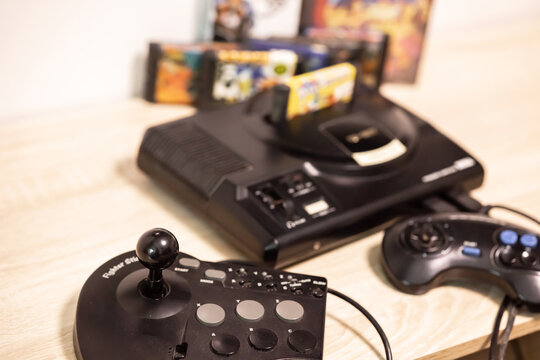 Sevastopol, Russia: July 11, 2023: Sega Megadrive vintage retro home game console Genesis  produced by Sega. Retro joystick with buttons, fighter stick MD 6 for the. Famous 16 bit entertainment system