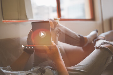 man using computer tablet apps, watching contents reading good news in social network, happy older female sitting on couch, holding electronic device, looking at screen