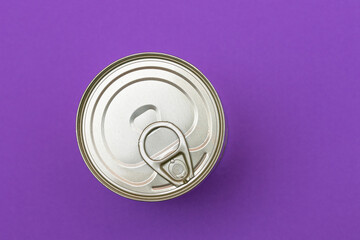 Unopened Tin Can with Blank Edge on Violet Background. Canned Food. Aluminum Can for Safe and Long Term Storage of Food. Steel Sealed Food Storage Container