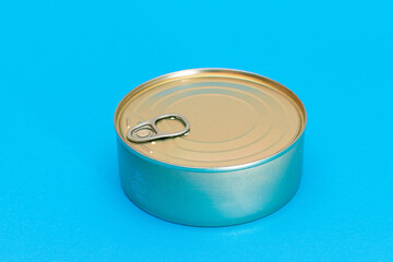 Unopened Tin Can with Blank Edge on Light Blue Background. Canned Food. Aluminum Can for Safe and Long Term Storage of Food. Steel Sealed Food Storage Container