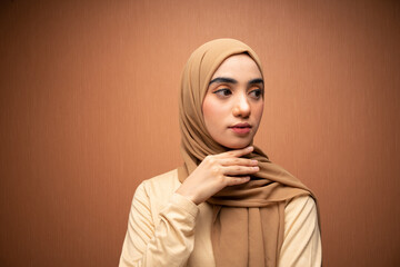 happy mixed race women hijab beauty photo in orange background