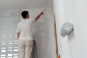 painter man, brush in hand for products to restore and paint the wall, indoor the building site of a house, wall during painting, renovation, painting, contractor, Architect, construction worker