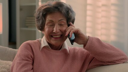 Happy old woman talking mobile phone with friends smiling laughing senior grandma talk distant chat elderly lady female retired granny grandmother talk smartphone with children excited sharing news - Powered by Adobe