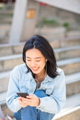 Fototapeta premium young woman looking at mobile phone