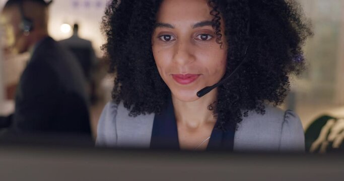 Call center, face and a woman with a headset at a computer for crm, online chat or advice. African female consultant working late for telemarketing, customer service or technical support at help desk