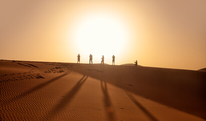Photographers taking pictures at sunrise in the Sahara desert - Sahara, Morocco